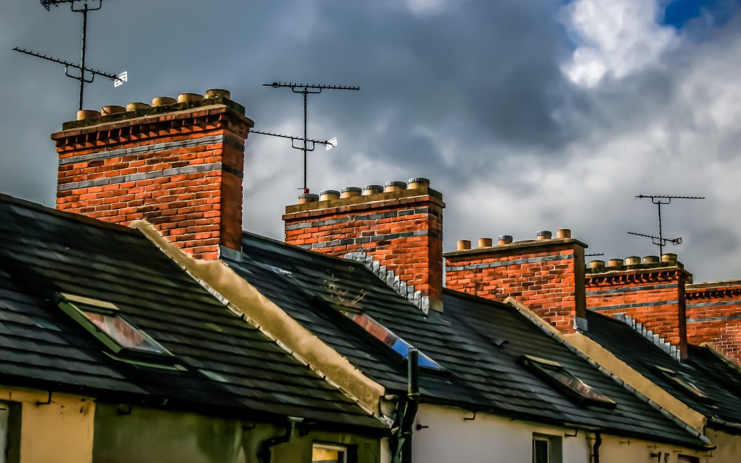 Roofs of terraced houses underneath a stormy sky
